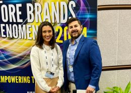 Two people standing in front of a sign that says The Store Brands Phenomenon