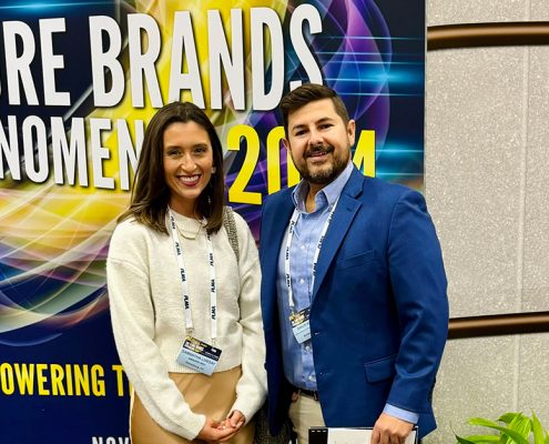 Two people standing in front of a sign that says The Store Brands Phenomenon