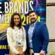 Two people standing in front of a sign that says The Store Brands Phenomenon