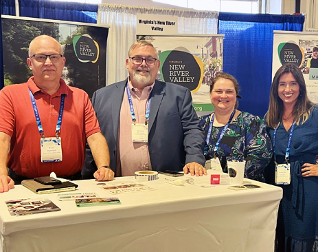 Four people standing at a lead genration conference
